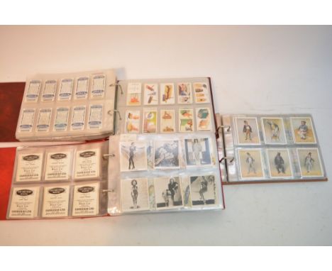 A collection of five albums of cigarette cards