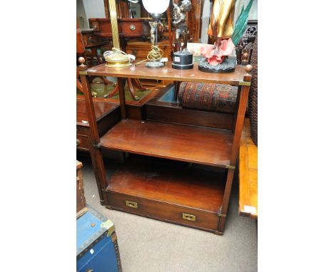 A campaign style three shelf unit with brass mounts