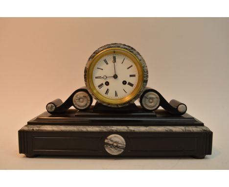 A black and white marble mantle clock with key, approximately 40cm long