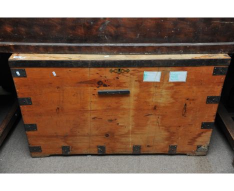 A very large pine trunk with metal straps