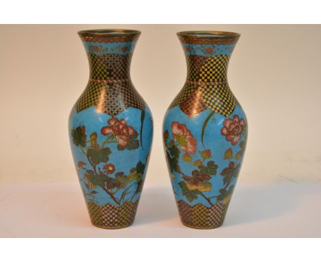 A pair of cloisonne vases with floral decoration on a light blue ground, approx 18cm.