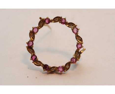 A ruby and diamond brooch in 9ct gold