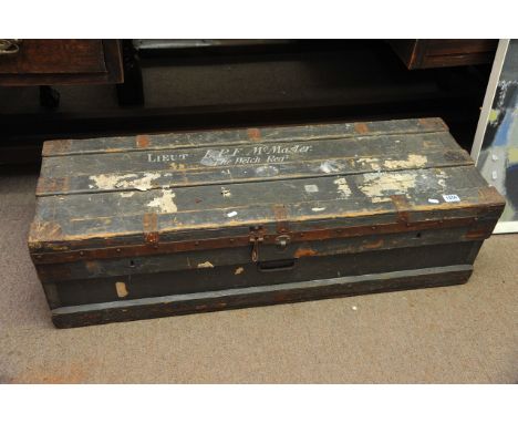 A large military wood and metal lined trunk, the top painted with name L.P.T McMaster, The Welch Regt'