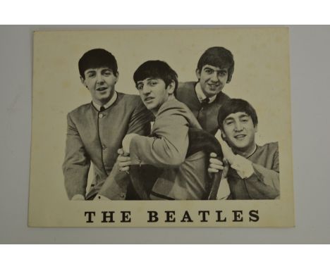 A signed Beatles postcard signed by all four members of the group to the reverse.