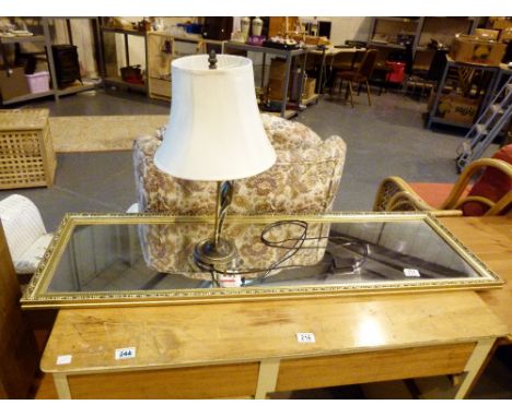 Gilt framed mirror and a figural nude table lamp