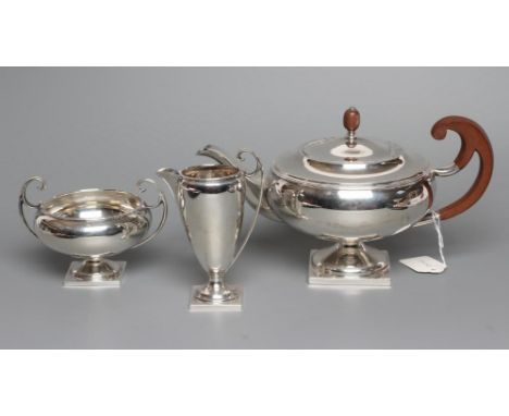 A THREE PIECE TEA SERVICE, maker James Ramsey, Sheffield 1929 (jug 1926), of squat globular form with reeded rim and raised u