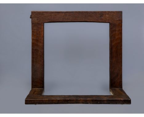 A ROBERT THOMPSON ADZED OAK FIRE SURROUND, c.1930's, of plain square section with mildly arched lintel and including a hearth