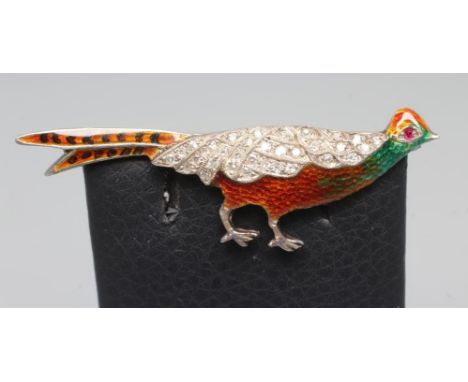 AN EDWARDIAN DIAMOND AND ENAMEL NOVELTY BROOCH modelled as a cock pheasant with pave set diamond wings and a single ruby eye,
