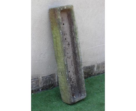 A SANDSTONE TROUGH of rough hewn narrow oblong form, 47 1/2" x 12" x 7 1/2" (Est. plus 24% premium inc. VAT)Losses to one top