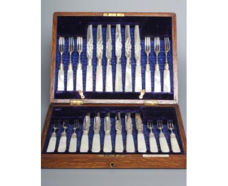 A SET OF TWELVE EDWARDIAN FRUIT KNIVES AND FORKS, maker R & W Sorley, Sheffield 1908, with foliate engraved blades and tines,