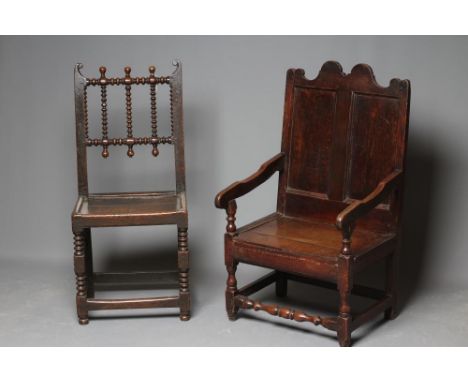 A JOINED OAK ARMCHAIR, early 18th century, the twin panelled back with waved top rail, shaped downswept arms on baluster turn