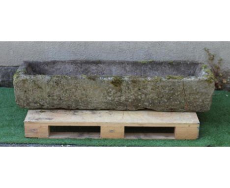 A SANDSTONE TROUGH of rough hewn narrow oblong form, 58" x 16" x 11" (Est. plus 24% premium inc. VAT)Good on one long side an