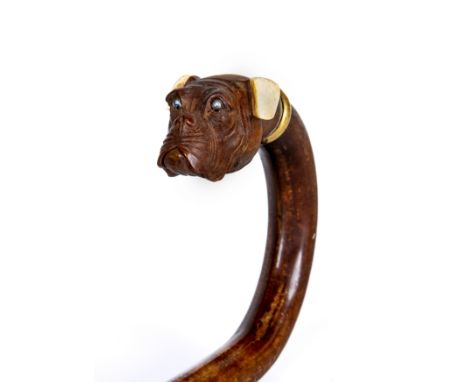 A VICTORIAN WALKING STICK, the boxwood(?) tip carved as a dog's head with glass eyes, ivory ears and hinged lower jaw reveali