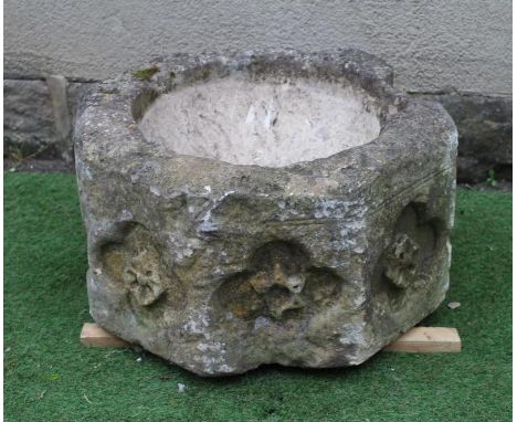 A SUBSTANTIAL SANDSTONE PLANTER, 19th century, of deep circular form carved with a band of flowerheads within quatrefoils, 26