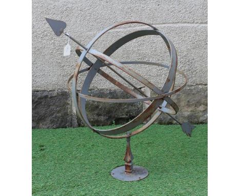 A WROUGHT IRON ARMILLARY SPHERE with spear head finial, on triangular stem and circular base, 28 1/2" x 29" (Est. plus 24% pr