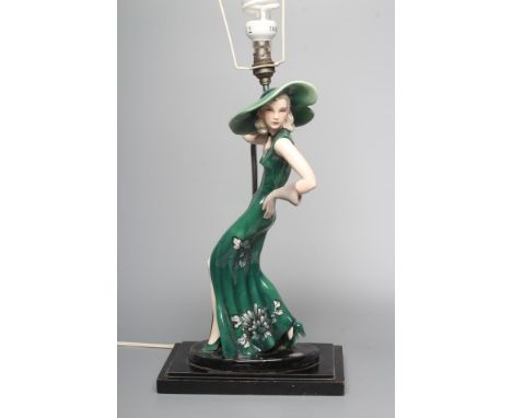 AN ART DECO GOLDSCHEIDER EARTHENWARE FIGURE modelled as a young fashionable lady wearing a wide brimmed green hat and flower 