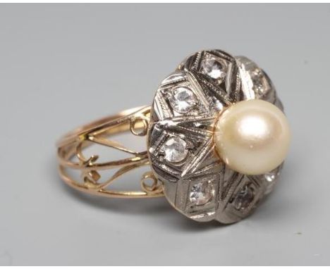 A PEARL AND DIAMOND COCKTAIL RING, the peg set cultured pearl within a white metal petal border set with eight small diamonds