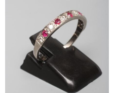A RUBY AND DIAMOND HALF HOOP RING, the five rubies and six diamonds point set to a plain white shank stamped 18ct, size P (Es