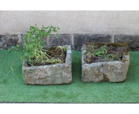 A SMALL SANDSTONE TROUGH of mildly irregular oblong form, 19/ 2" x 18 1/2" x 10", together with another, similar, 19" x 18" x