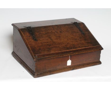 A GEORGIAN OAK BOARDED BOX DESK, mid 18th century, the moulded edge slope with wrought iron strap hinges and book stay openin