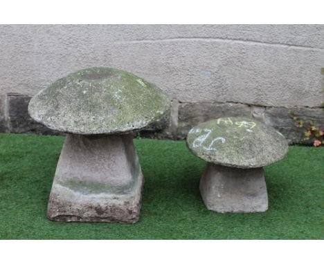 A CAST STONE MUSHROOM on square tapering base, 21 1/2" x 23", together with a similar smaller item, 17" x 13 1/2" (2) (Est. p