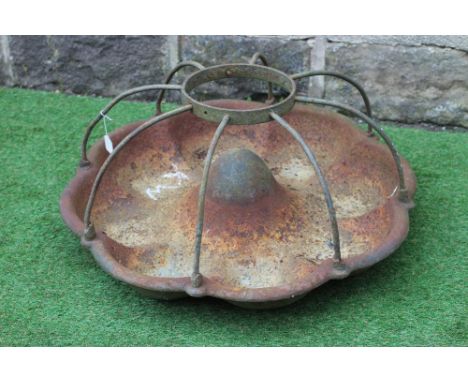 A CAST IRON PIG TROUGH, 20th century, of circular form with raised circular food aperture, 30" wide (Est. plus 24% premium in