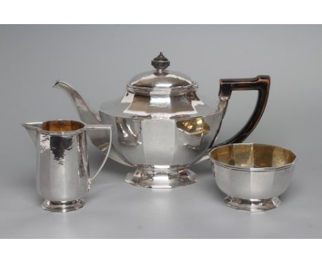 AN ART DECO THREE PIECE TEA SERVICE, maker's mark WS over HS, London 1927, of angled cylindrical form raised on a spreading f