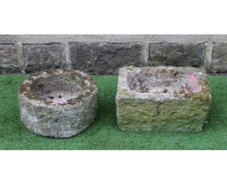 A SANDSTONE TROUGH of rough hewn circular form, 15 1/2" x 8", together with another of oblong form, 18" x 12 1/2" x 9" (2) (E