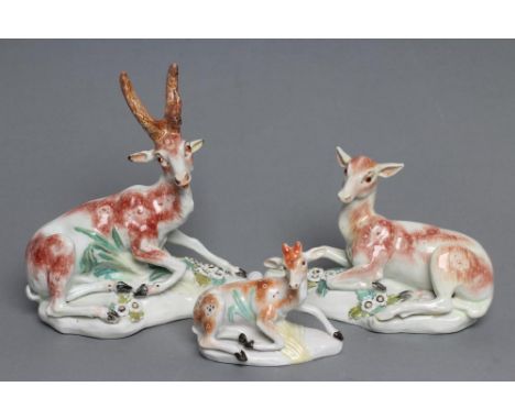A DERBY PORCELAIN STAG AND HIND, c.1760, each modelled recumbent on a flower encrusted shaped base, patch marks, stag 6 1/2" 