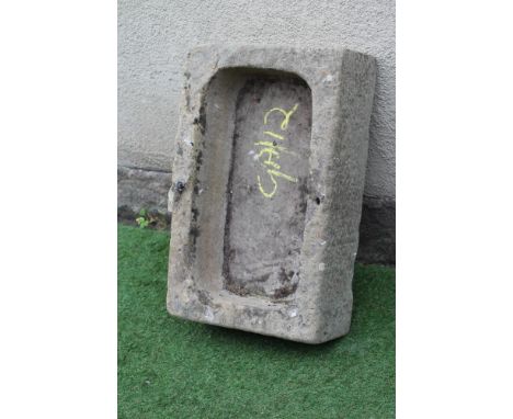 A SANDSTONE TROUGH of rough hewn oblong form with mildly raised back, 28 1/4" x 17 1/2" x 8 1/2" (Est. plus 24% premium inc. 