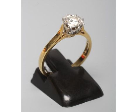 A SOLITAIRE DIAMOND RING, the round brilliant cut stone of 0.31cts illusion set to a plain 18ct gold shank, London 1976, spon