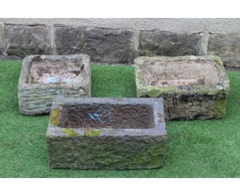 A SMALL SANDSTONE TROUGH of rough hewn oblong form, 18" x 12"x 8", another, 20" x 11"x 7 3/4", and a square trough, 13 1/2" x