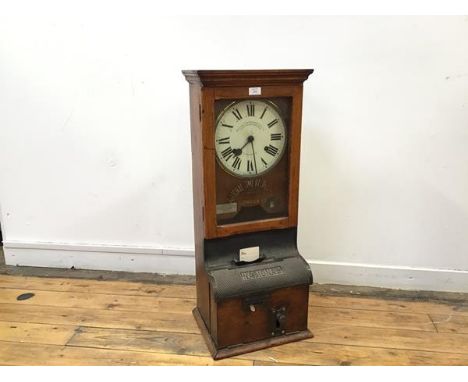 A National Time Recorder, the circular enamelled dial with arabic numerals and manufacturers details within an oak case with 