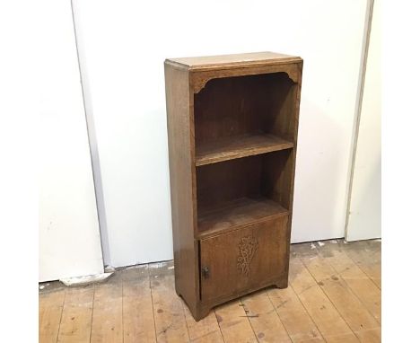 An Edwardian oak bookcase of small proportions, the rectangular top with moulded edge above an open shelf with cupboard below