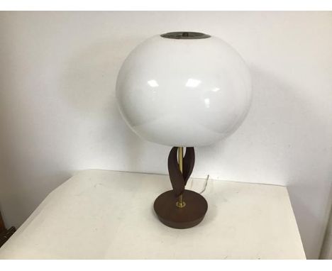 A mid century style table lamp, the opaque acrylic dome shaped shade supported by a brass stem flanked by two stylised flames