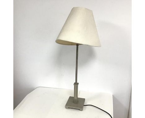 A polished steel table lamp with circular stem above a square plinth, on square base with bracket feet (shade a/f) (h.71cm ba