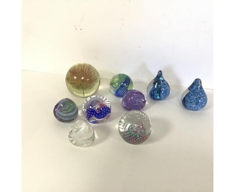A collection of Caithness glass paperweights including Reflections, Weaver, Pebbles, Raindrops (8) and a Flowerhead encased i