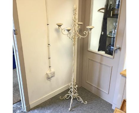 A four arm floor standing candelabrum with multiple C scrolls and a pine cone finial, painted iron (h.158cm x 56cm x 56cm)