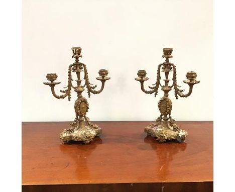 A pair of 20thc brass candelabra in the Neoclassical taste, each baluster shaped shaft embellished with floral garlands, rais