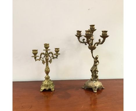 A 20thc brass candelabra, the five branches with drip trays supported by a depiction of Venus, raised on a pierced base, and 