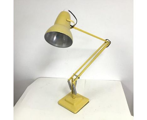 A mid 20thc anglepoise table lamp stamped Herbert Terry &amp; Sons Ltd., on a two tier base, painted yellow (height max: 88cm