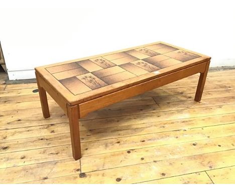 A modern tile top coffee table, the rectangular top above an arrangement of tiles, raised on moulded square section legs (37c