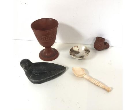 An Inuit carved hardstone bird inscribed Minnie and numbered to base (8cm x 11cm x 5cm), a terracotta goblet and pipe bowl, a