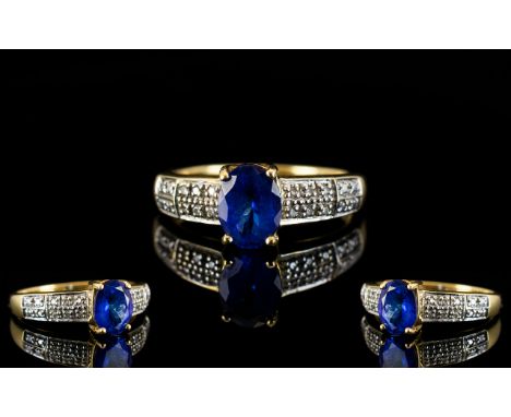 18ct Gold - Attractive Tanzanite and Diamond Set Dress Ring, Full Hallmark for 750 - 18ct. The Central Faceted Tanzanite with