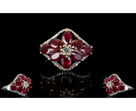 Ruby Flower Lozenge Shape Ring, eight oval cut rubies, of good, strong colour, in a stylised flower shape, around a central w