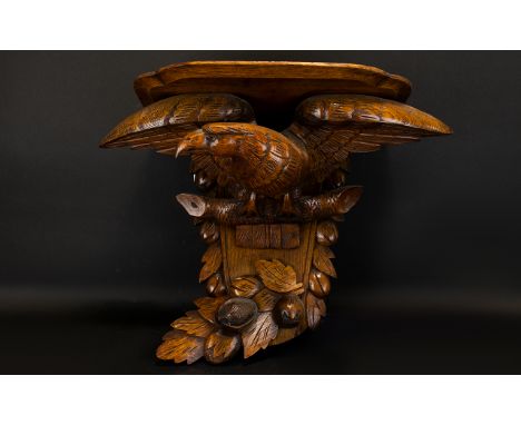 A 1920's Golden Oak Clock Bracket Modelled In The Form Of An Eagle With Outstretched Wings, Height 14½ Inches, 19½ Inches Wid