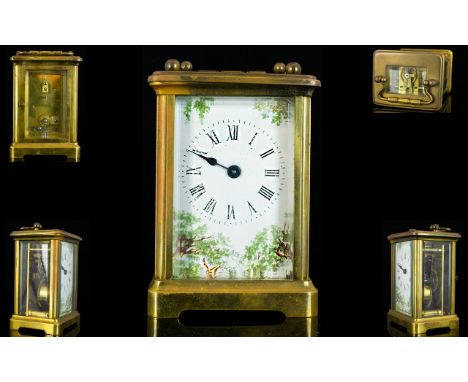 Brass Framed Carriage Clock Of Typical form, white enamel dial with transfer printed shrubbery decoration, Roman numerals, he