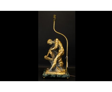 A Cast Metal Figural Lamp Base Raised on verde marble base, the figure in the form of a male nude engaged in Herculean task, 