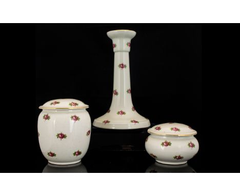 Shelley Dressing Table Set comprising three pieces, a 7" tall candlestick, a lidded pot approximately 4" high, and a small li