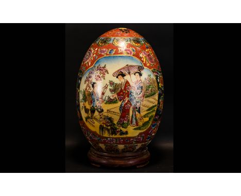 A Large Oriental Ceramic Egg. Raised On Circular Wooden Stand, The Body Decorated With Two Vignettes Each Depicting Courtesan